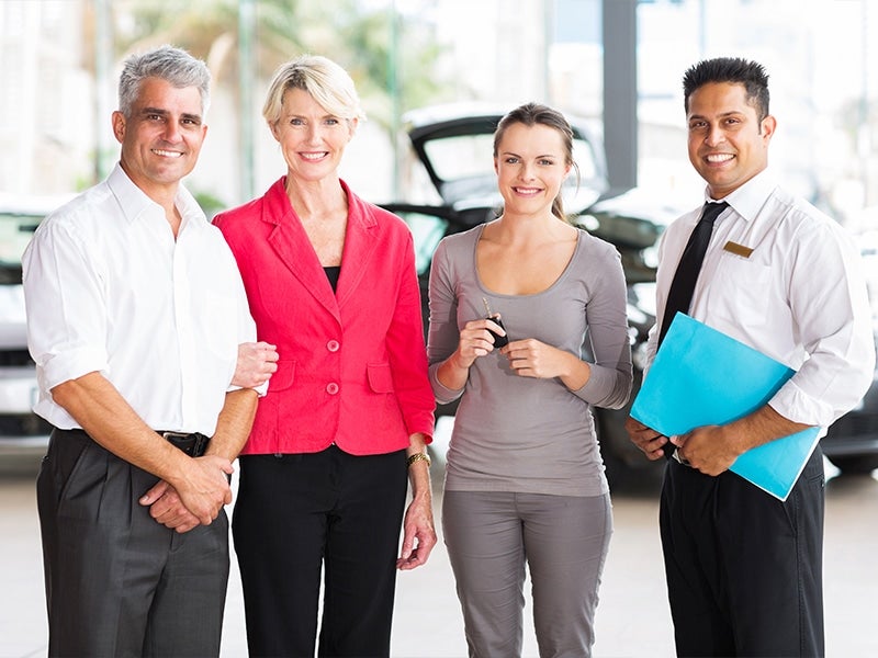 four persons standing in a showroom
