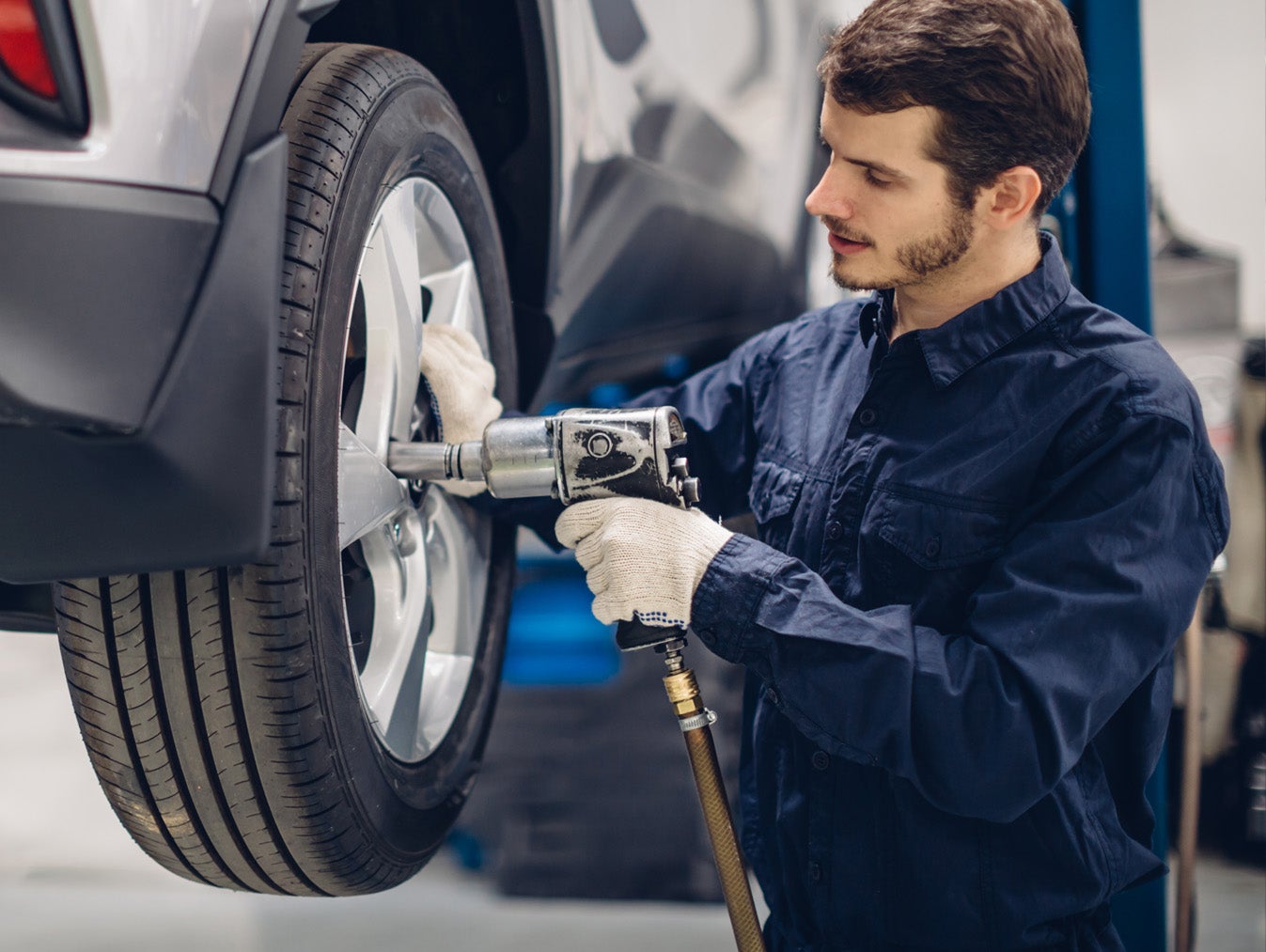 man doing servicing of car tire